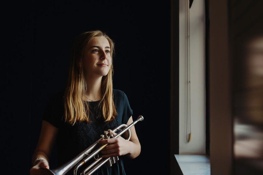 a student in the popular music degree holds a trumpet